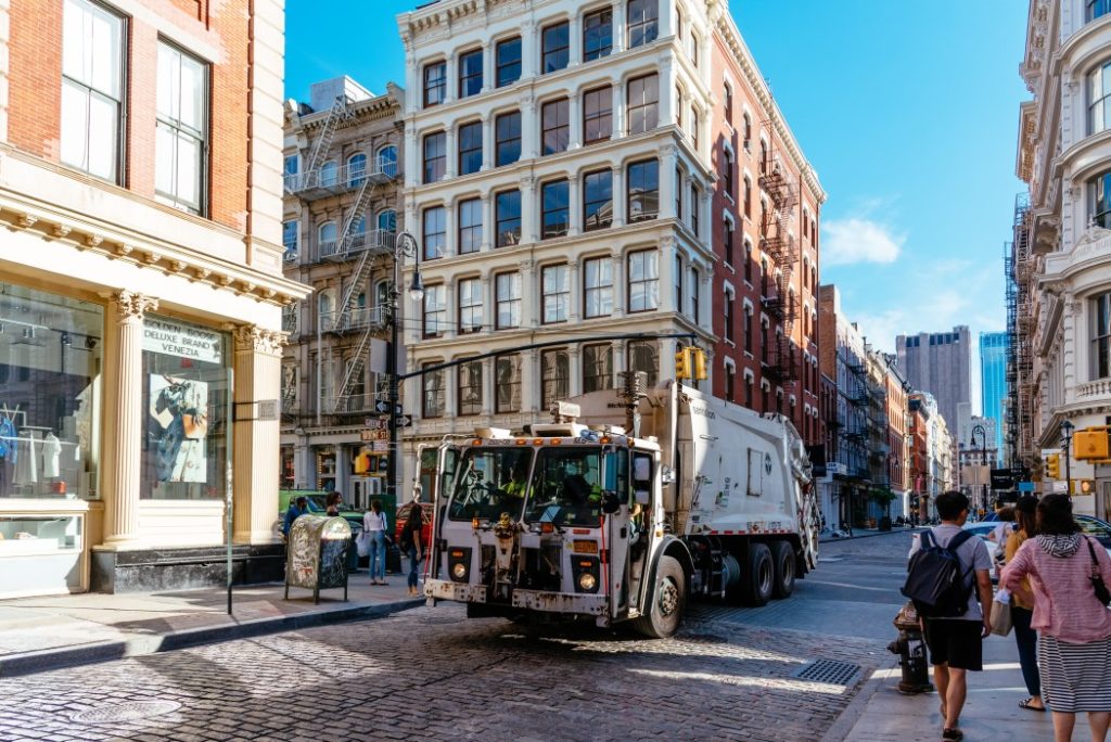 garbage truck in greene street with luxury fashion retail stores in soho cast iron historic district t20 znPm2Q Green Trucking is Cleaner Than Green Buildings