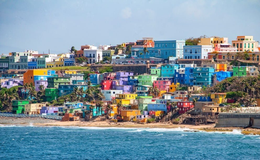 colorful houses line the hillside over looking the ocean on the island of san juan puerto SeaPods Create an Exciting Way to Waterfront Living