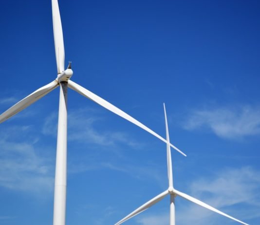 wind turbines churning out electric power love our planet wind turbines in a blue sky background t20 9km108 China Building World’s Largest Offshore Wind Farm — 43.3 Gigawatts