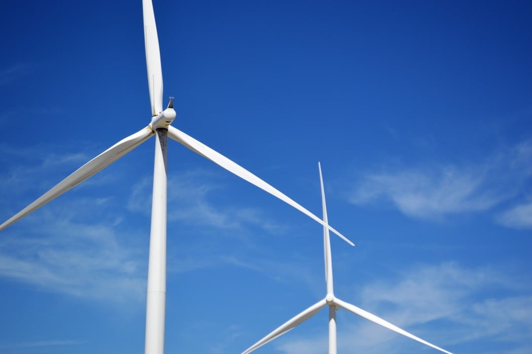 wind turbines churning out electric power love our planet wind turbines in a blue sky background t20 9km108 China Building World’s Largest Offshore Wind Farm — 43.3 Gigawatts