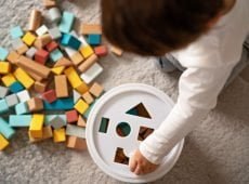 top view of little toddler boy playing with wooden colorful building blocks sorting shapes child t20 1nlBWO Best Eco Toy Design | Junior Design Awards 2021