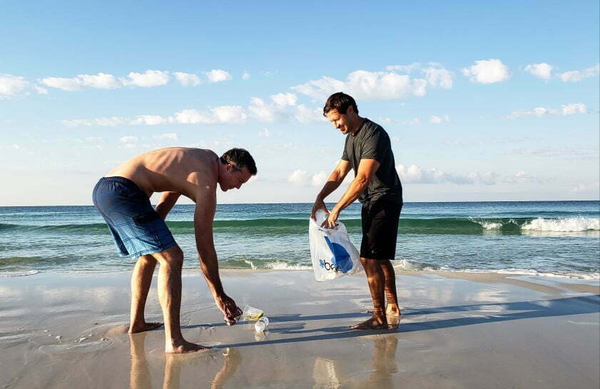 two friends picking up trash left by trashy uncaring people while on vacation at the beach because t20 YEVvBO Trash Talk