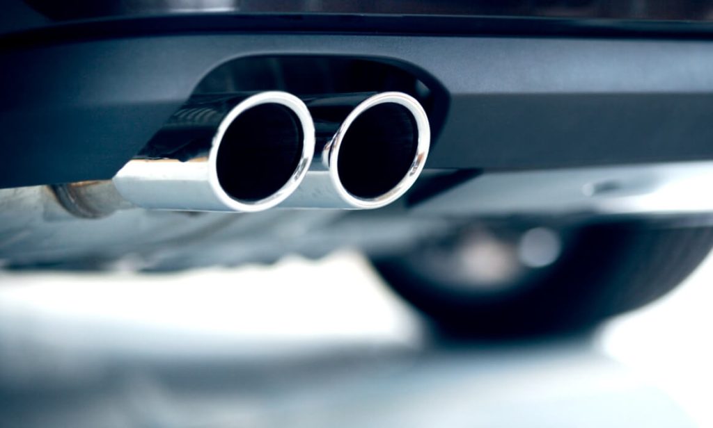 Emissions Continue to Decrease as Automakers Focus on Green Goals Image of a new vehicle's tailpipe.