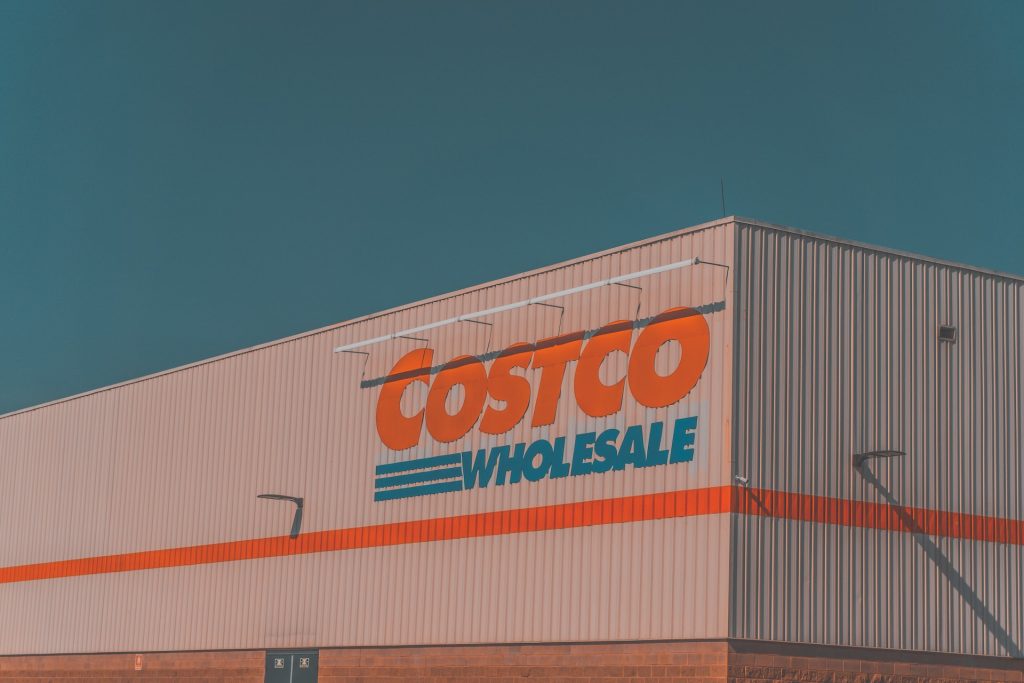 Fifth Biggest Retailer in the World is Going Green. Image of a Costco Warehouse against a blue sky. 