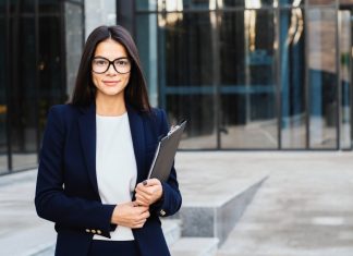 portrait of young successful businesswoman wearing glasses and looking to camera professional female t20 bA0NWB How to Reduce the Carbon Footprint of Your Business 